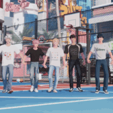 a group of young men are standing on a basketball court with one wearing a shirt that says champs on it