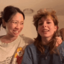 two women are posing for a picture with one wearing a shirt that says ' i 'm sorry '
