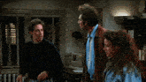 two men and a woman standing in a room with the words now don t you two see