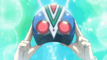 a person is holding a mask in their hands that has a v on it