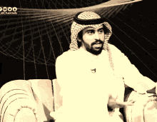 a man with a beard is sitting on a couch with jdchannels written on the bottom right