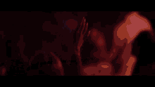 a blurry picture of a group of people raising their hands