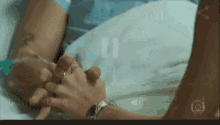 a person holding another person 's hand in a hospital
