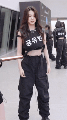 a woman wearing a black crop top with korean writing