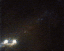 a blurry picture of a dark room with a few lights on