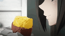 a girl with long hair looks at a piece of food