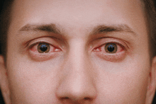 a close up of a man with red eyes