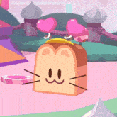 a slice of bread with a cat face and ears is sitting on a table .