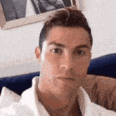 a man is sitting on a couch taking a selfie .