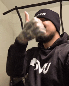 a man wearing a beanie and a shirt that says evo on it