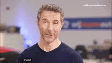 a man in a blue shirt with the word hallo on it