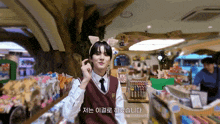 a boy wearing a cat ear headband is standing in a store .