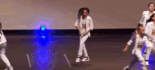 a group of young people are dancing on a stage .