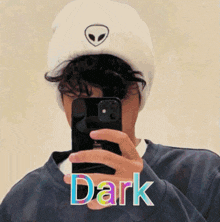 a person taking a picture of themselves with the word dark written on the bottom