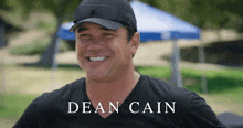 a man with the name dean cain on the bottom of his shirt