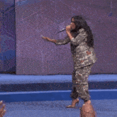 a group of women are clapping their hands in the air