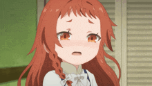 a close up of a girl with red hair making a funny face