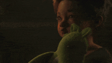 a young boy is holding a stuffed animal in his hands .