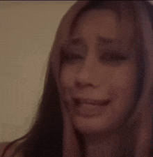 a close up of a woman 's face with a tear running down her cheek .