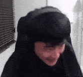 a man wearing headphones is sitting in a chair .