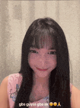 a girl with long black hair and bangs is smiling with gbs guyss gbs ak written below her