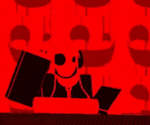 a black and red cartoon character is sitting at a table holding a book and wearing headphones .
