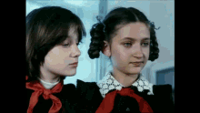a boy and a girl are standing next to each other and looking at something