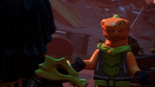 two lego figures standing next to each other with one wearing a green scarf