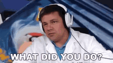 a man wearing headphones and a white lab coat is asking what did you do .