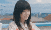 a close up of a girl 's face with asian writing on the bottom