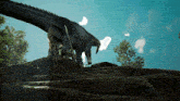 a statue of a dragon standing on top of a rock
