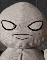 a close up of a stuffed animal 's face with a smile on it