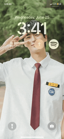 a phone screen shows a picture of a man in a school uniform on wednesday june 25