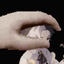 a pixelated image of a hand holding a person 's eye .