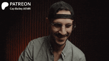 a man wearing glasses and a hat says stupid in front of a patreon logo