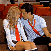 a man and a woman are sitting on a couch with the caption colucciyarango_