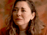 a close up of a woman 's face with a red background