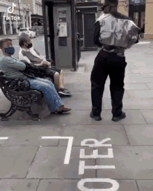 a man with a bag on his back is standing in front of a sign that says 7 feet