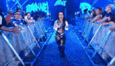 a woman in a wrestling outfit is walking down a blue aisle with romane written on it