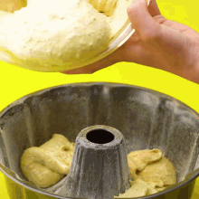 a person is pouring batter into a cake pan