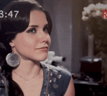 a close up of a woman 's face with the time 3:47 in the corner