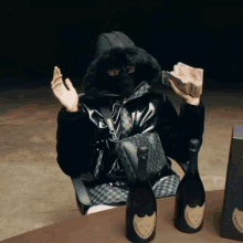 a man in a mask is sitting at a table with three bottles of champagne