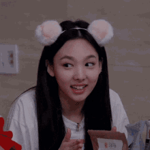 a young woman wearing a headband with cat ears on her head