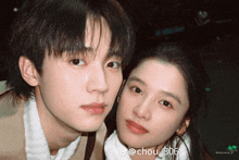 a man and a woman are posing for a picture with the name chou 306 on the bottom right