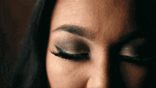 a close up of a woman with her eyes closed