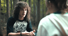 a man wearing a shirt that says hellfire club on it