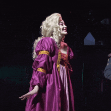 a woman in a purple dress with gold trim is screaming