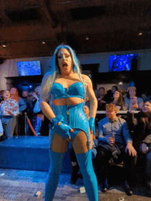 a drag queen performs in front of a crowd