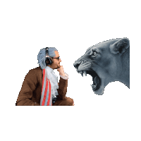 a man wearing headphones looks at a lion