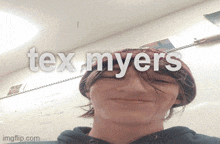 a person wearing a beanie with the words tex myers written on it